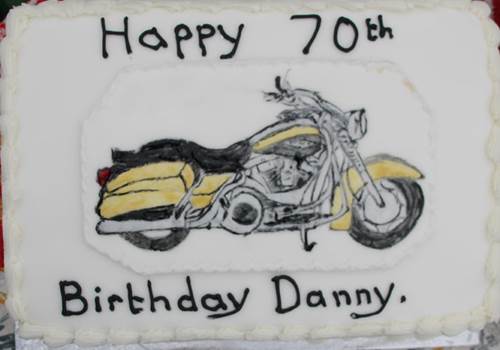 A cake with a picture of a motorcycle

Description automatically generated